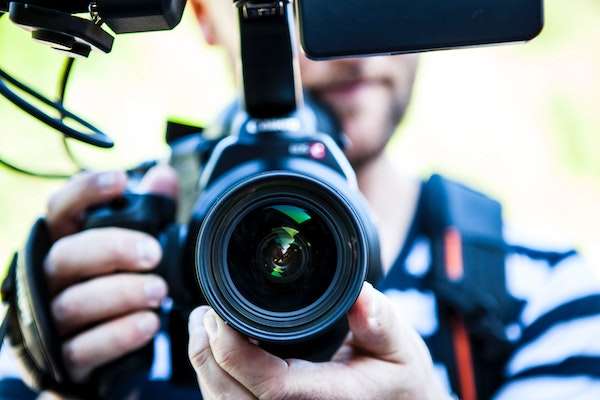 person with camera filming video