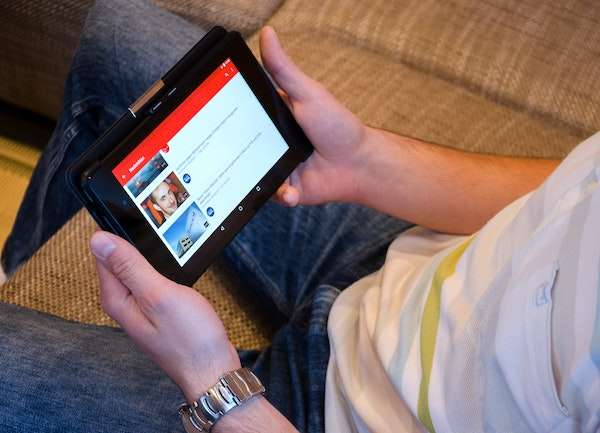 person watching youtube video on tablet